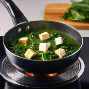 Palak Paneer Combining Spinach and Paneer in burner moden kichen in cooking